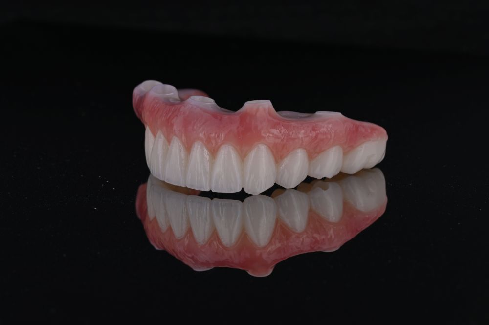full arch dental implants top teeth from side view on black background